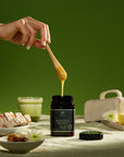 Dripping honey to make honey toast on breakfast table