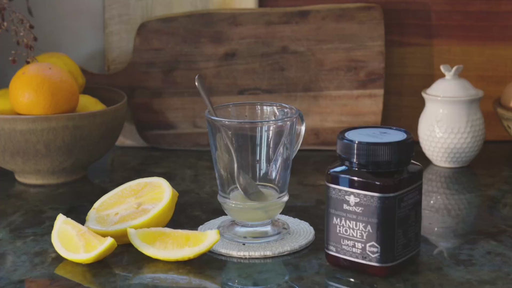 Video showing BeeNZ manuka honey umf15+ with a glass of lemon juice, then adding honey and hot water to the glass to make a hot lemon honey drink. 