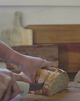 Video of BeeNZ Manuka Honey UMF5+. Bread being sliced to spread honey on. This Manuka honey is best for everyday use. 